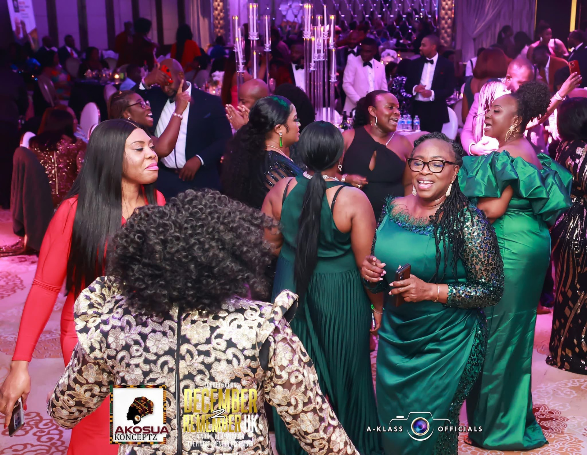 Guests in emerald evening wear celebrating together in the ballroom
